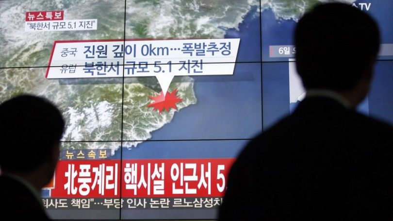 People walk by a screen showing the news reporting about an earthquake near North Korea's nuclear facility, in Seoul, South Korea, Wednesday, Jan. 6, 2016. South Korean officials detected an "artificial earthquake" near North Korea's main nuclear test site Wednesday, a strong indication that nuclear-armed Pyongyang had conducted its fourth atomic test. North Korea said it planned an "important announcement" later Wednesday. The letter read "5.1 Earthquake near North Korea's nuclear facility." (AP Photo/Lee Jin-man)